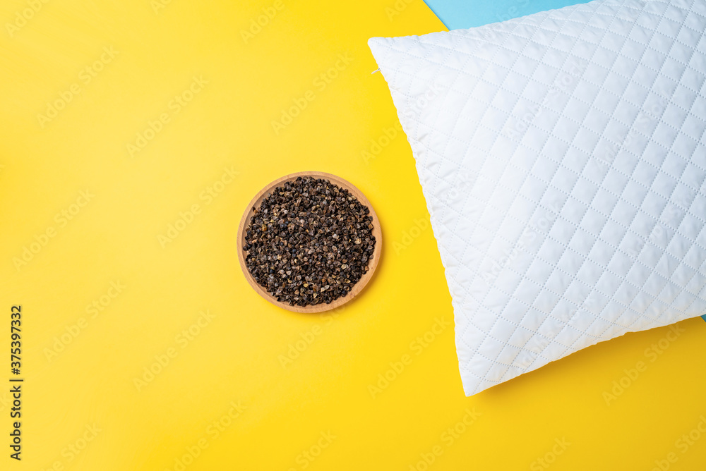 A plate of buckwheat husks and a white pillow