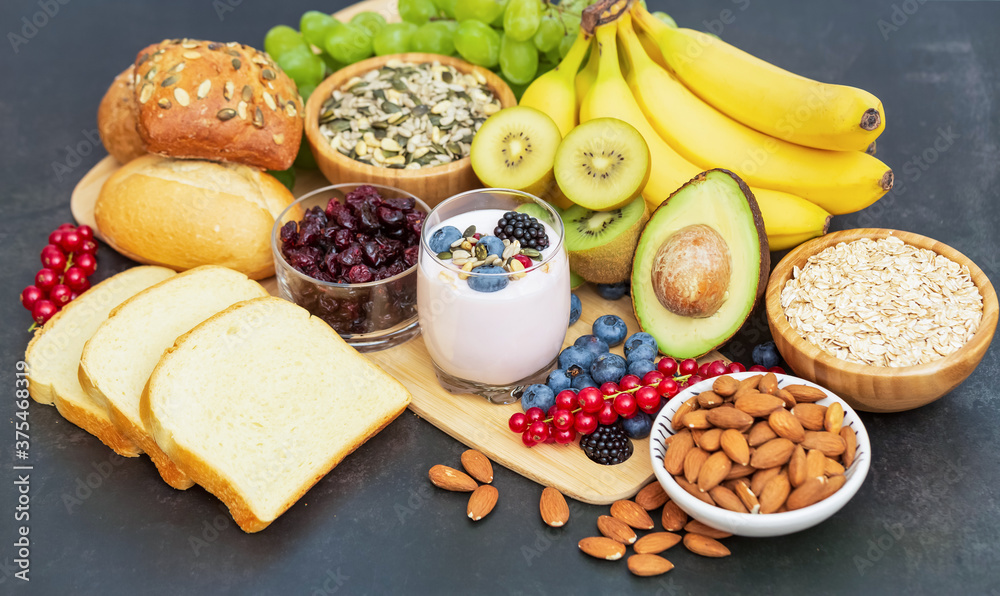 Group Fruits Breakfast with bread Whole grains and nuts, yogurt mix with Cherry , banana, avocado in