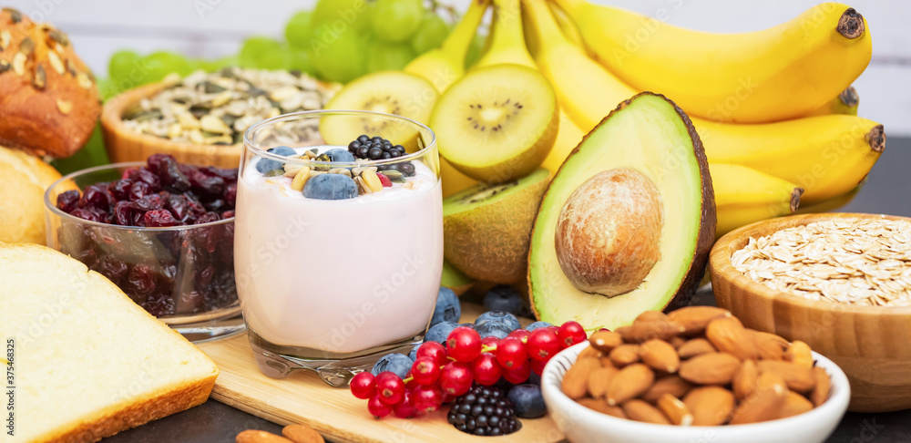 Group Fruits Breakfast with bread Whole grains and nuts, yogurt mix with Cherry , banana, avocado in