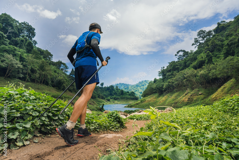 Runner, hes running a trail. In the mountain nature trail