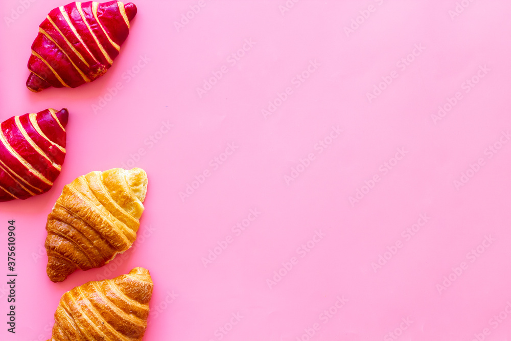 Set of croissants - berry, classic - on pink background top view