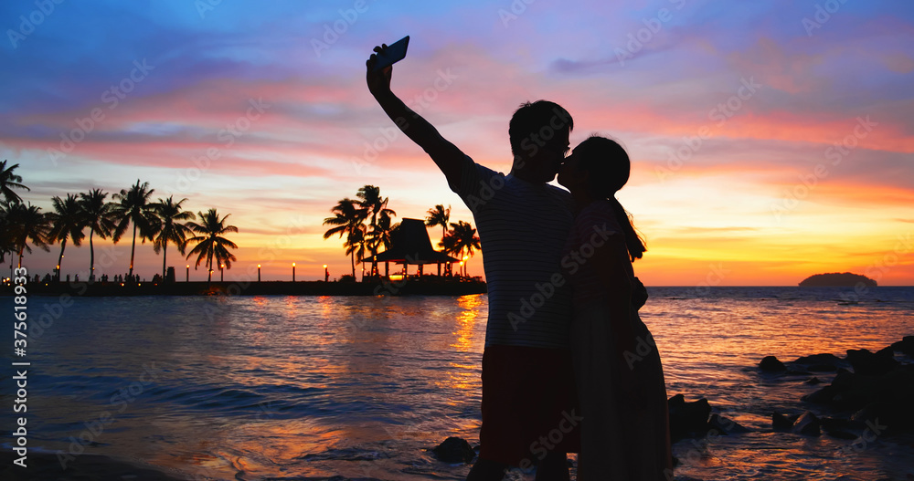 couple take sefie on beach