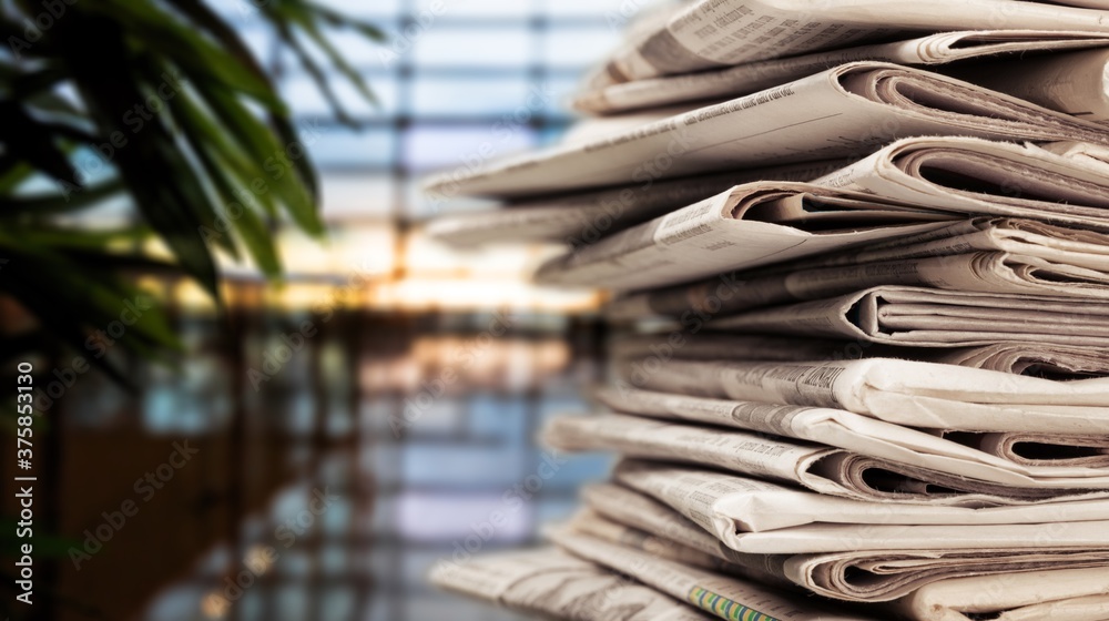 Pile of newspapers stacks on blur background