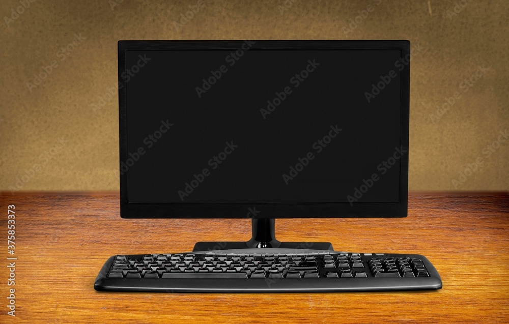 Modern desktop computer and keyboard on desk