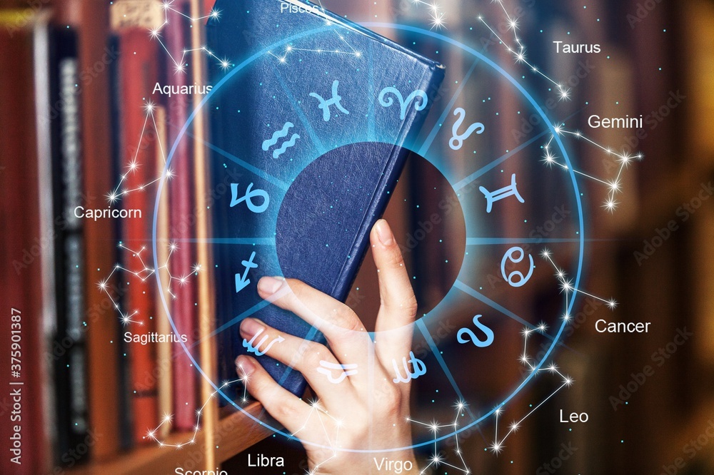 Female hand taking the book from the shelf in library and astrology illustrations