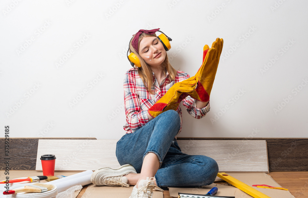 Happy girl in protective headphones and gloves