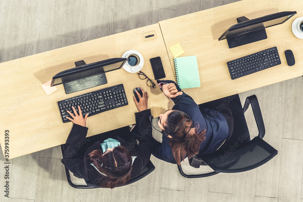 Business people wearing headset from top view in office working with computer to support remote cust