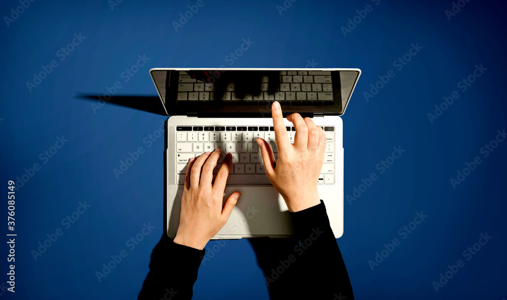 Person using a laptop computer from above