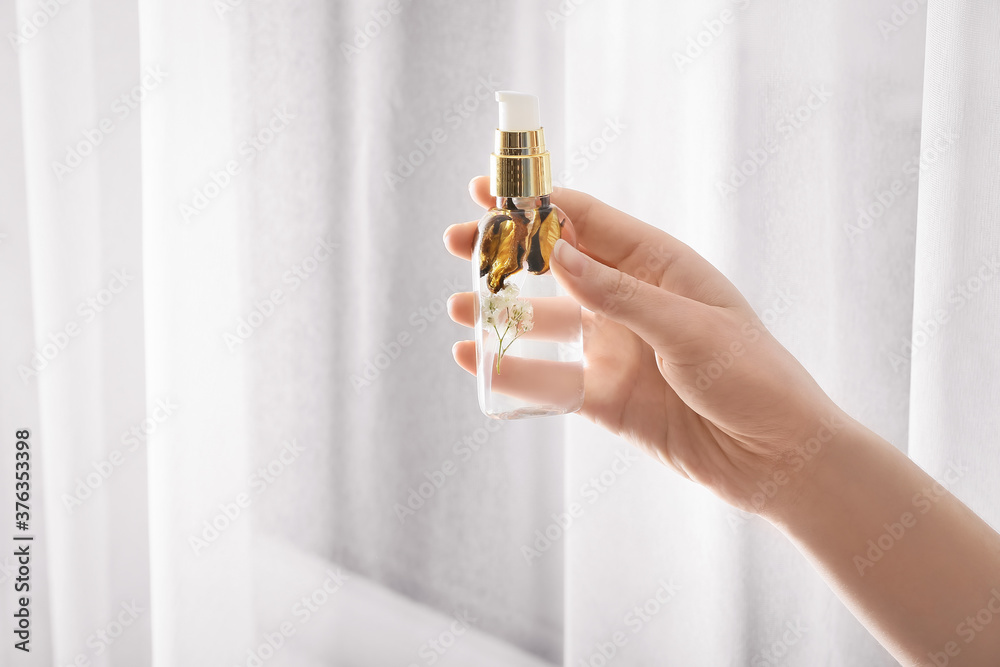 Woman using natural air freshener at home