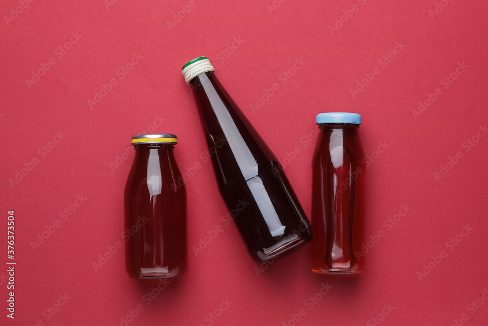 Bottles of juices on color background