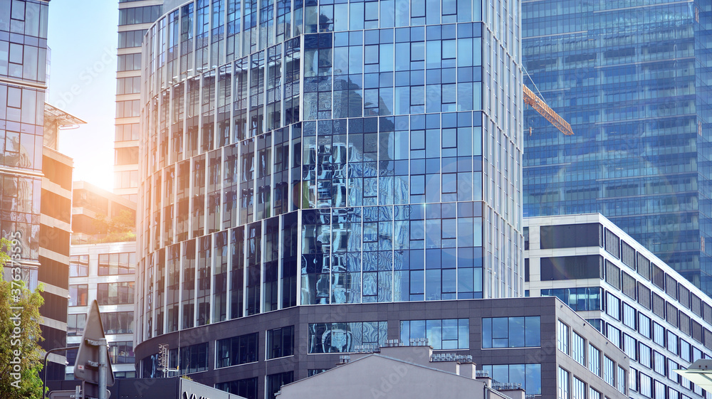 Office building, details of blue glass wall and sun reflections.