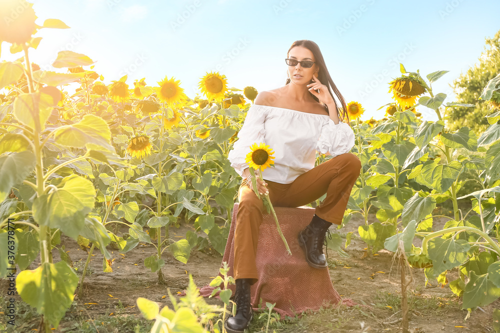 Beautiful young woman in sunflower field