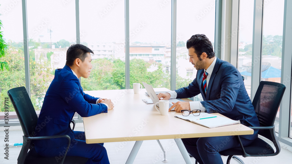 Job seeker in job interview meeting with manager and interviewer at corporate office. The young inte