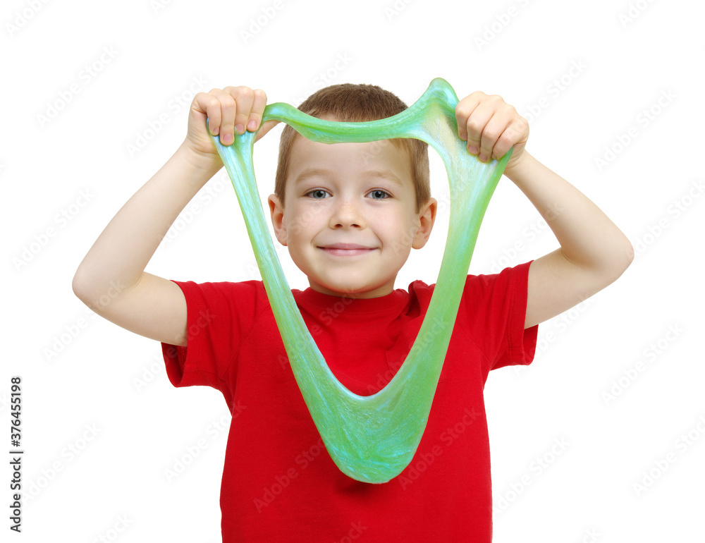 Boy stretches slime toy in hands and looks