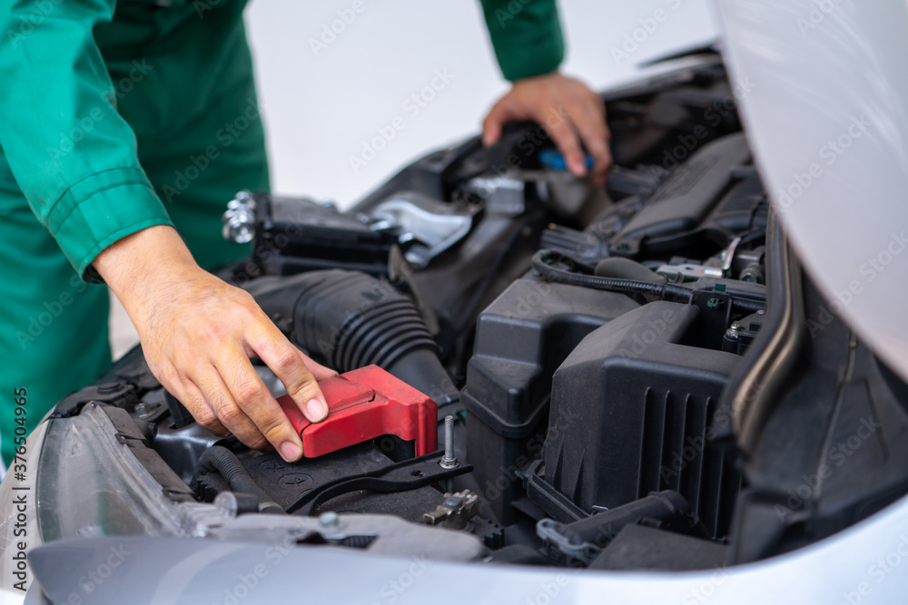 Professional mechanic hand providing car repair and maintenance service in auto garage. Car service 