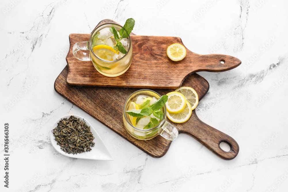 Cups of tasty cold ice tea on table