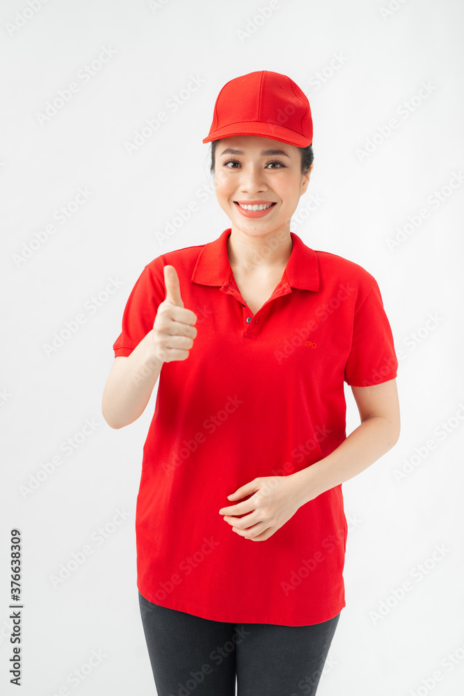 professional caucasian female in cap, t-shirt, jeans working as courier or dealer, showing thumbs up