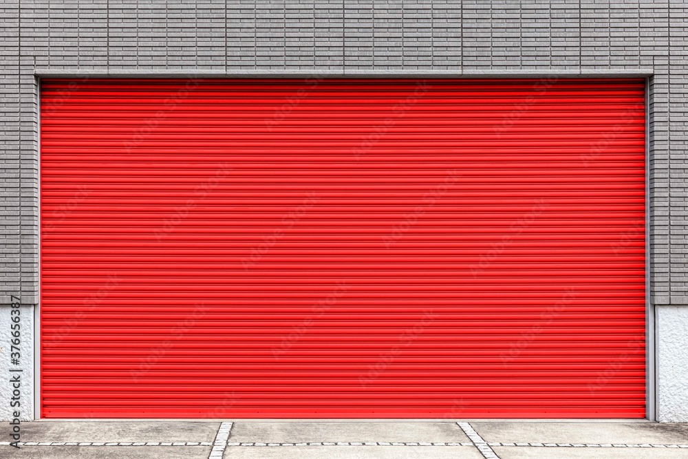 Automatic red roller shutter doors on the ground floor of the house