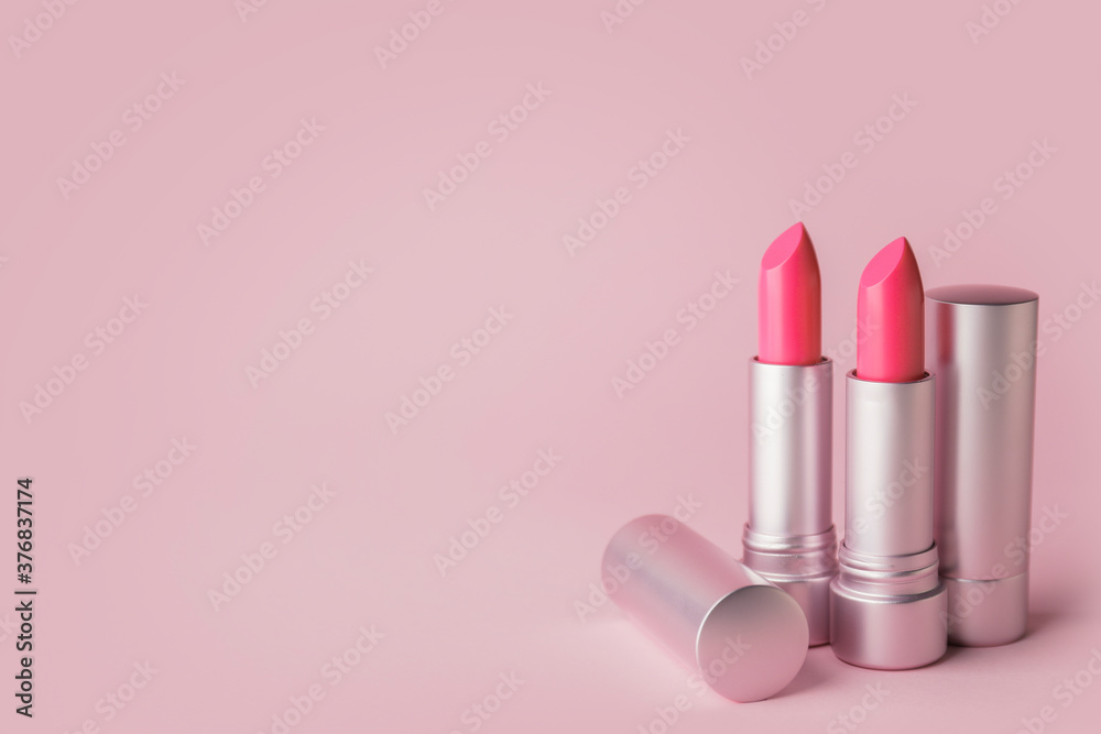 Different lipsticks on color background