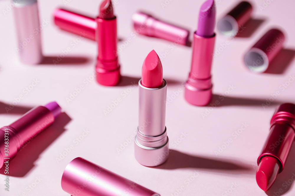 Different lipsticks on color background