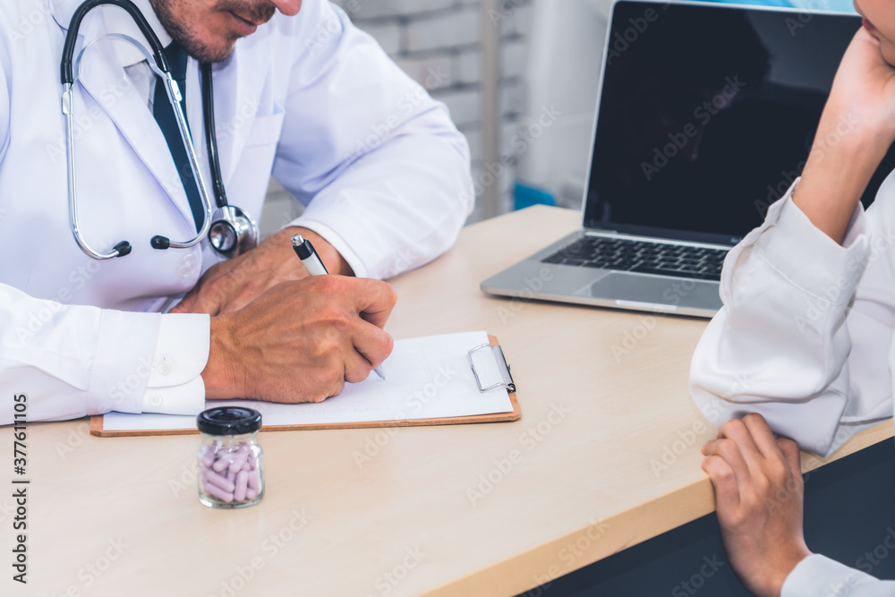 Doctor in professional uniform examining patient at hospital or medical clinic. Health care , medica