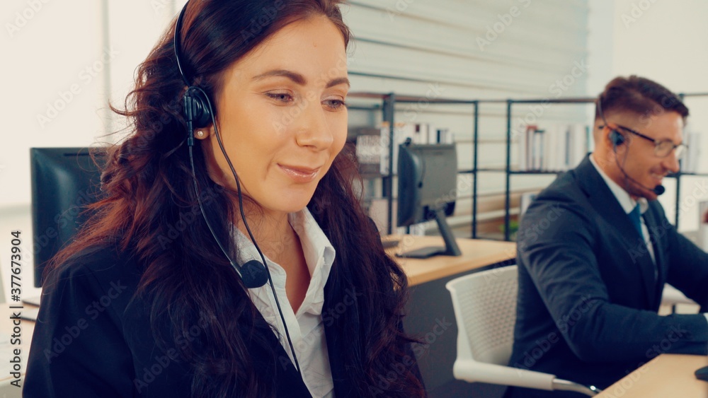 Business people wearing headset working in office to support remote customer or colleague. Call cent