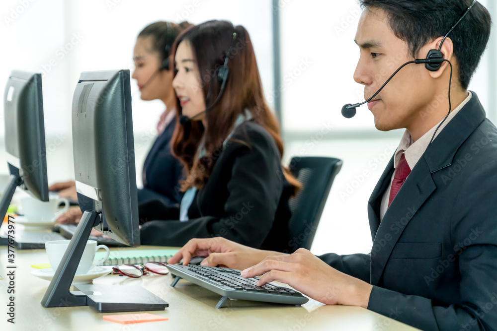 Business people wearing headset working in office to support remote customer or colleague. Call cent