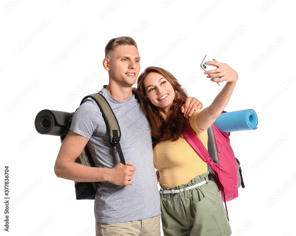 Couple of tourists taking selfie on white background