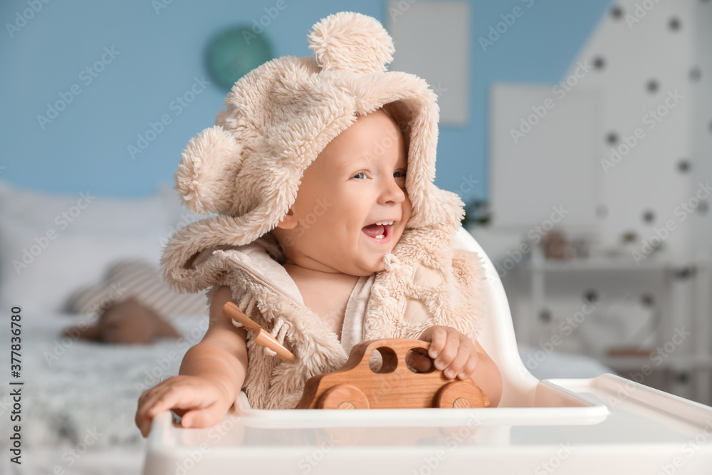 Cute little baby with toy at home