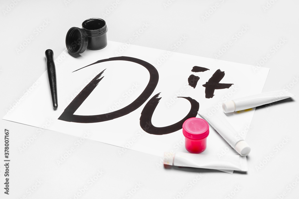 Supplies for calligraphy practice on white background