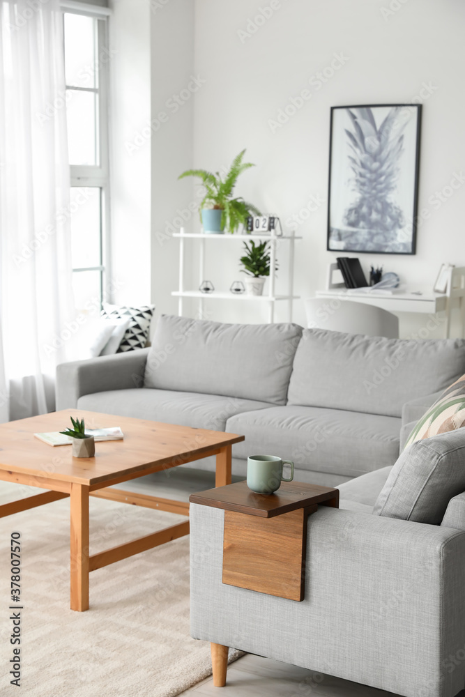 Armrest table on sofa in interior of room