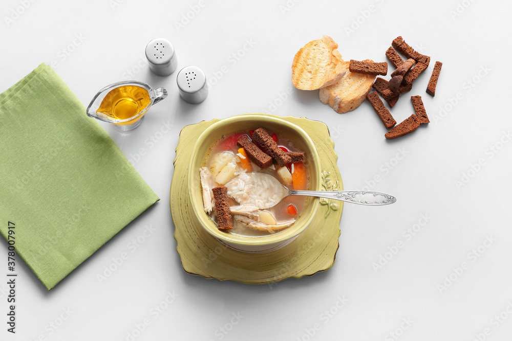 Bowl of tasty rice soup on white background