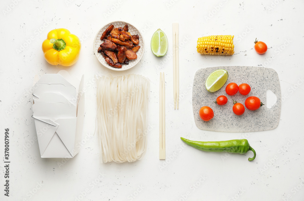 Raw rice noodles with ingredients on white background