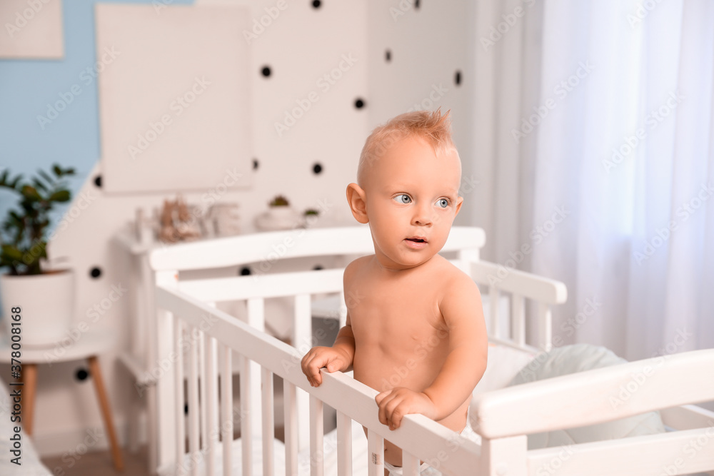 Cute little baby in bed at home