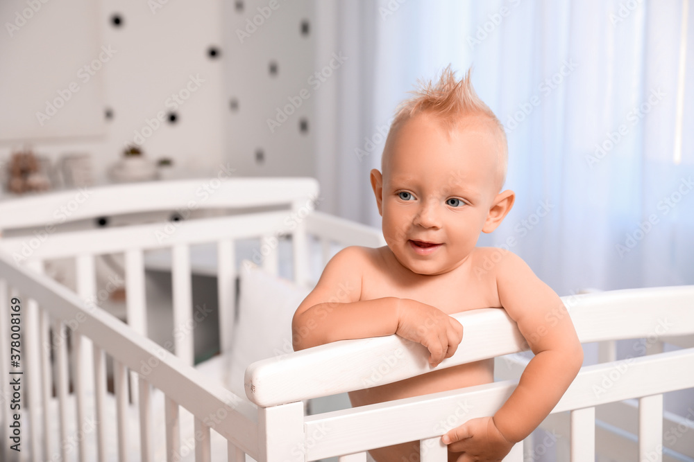 Cute little baby in bed at home