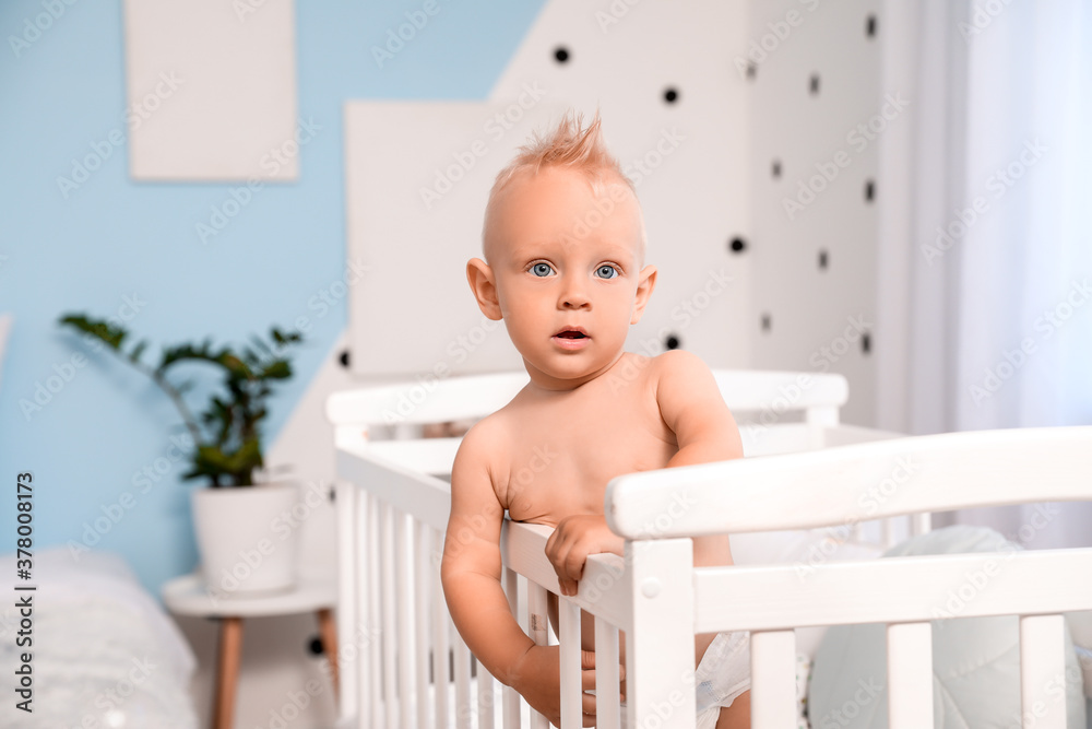 Cute little baby in bed at home