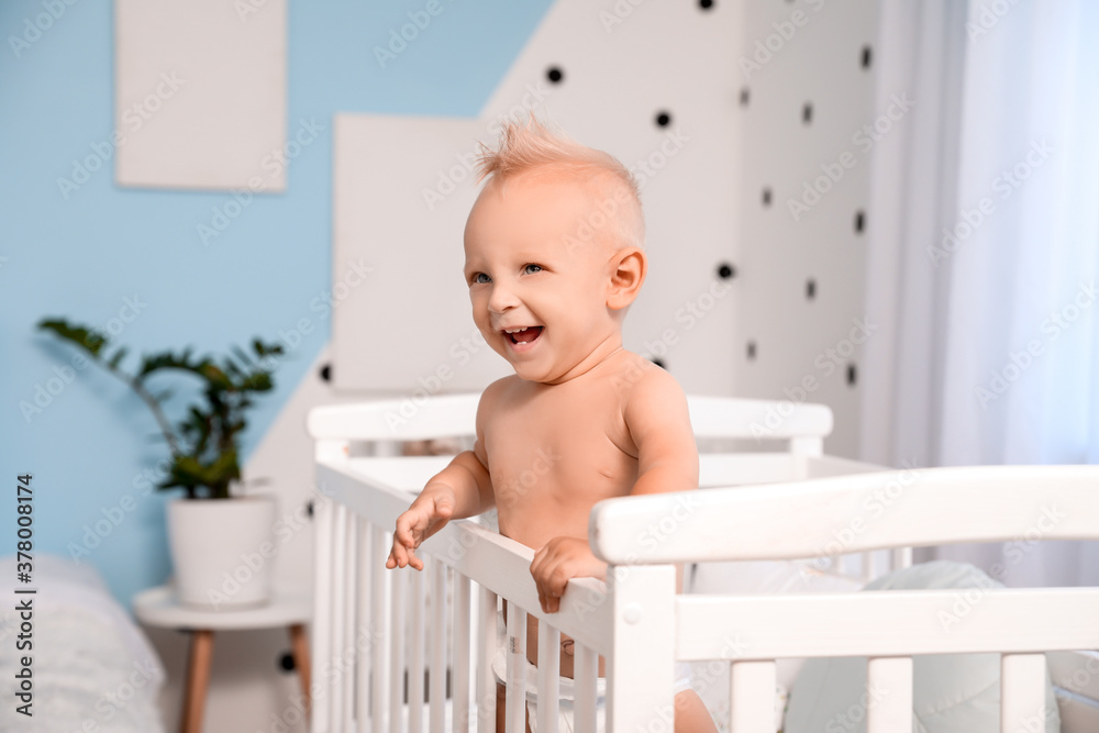 Cute little baby in bed at home