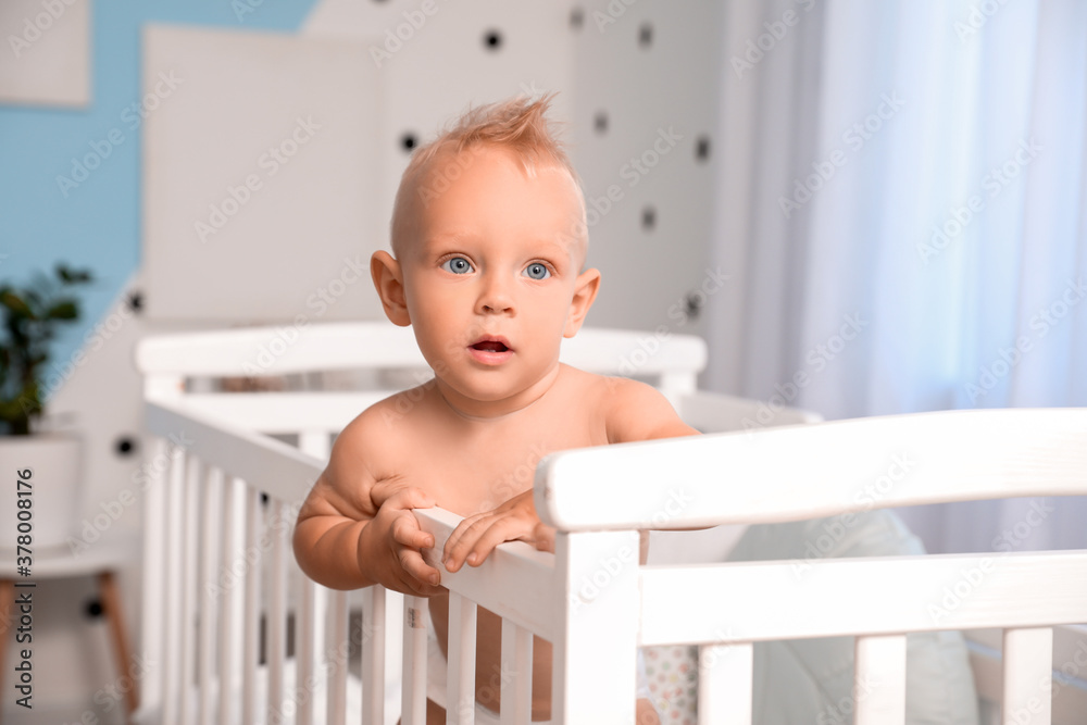 Cute little baby in bed at home