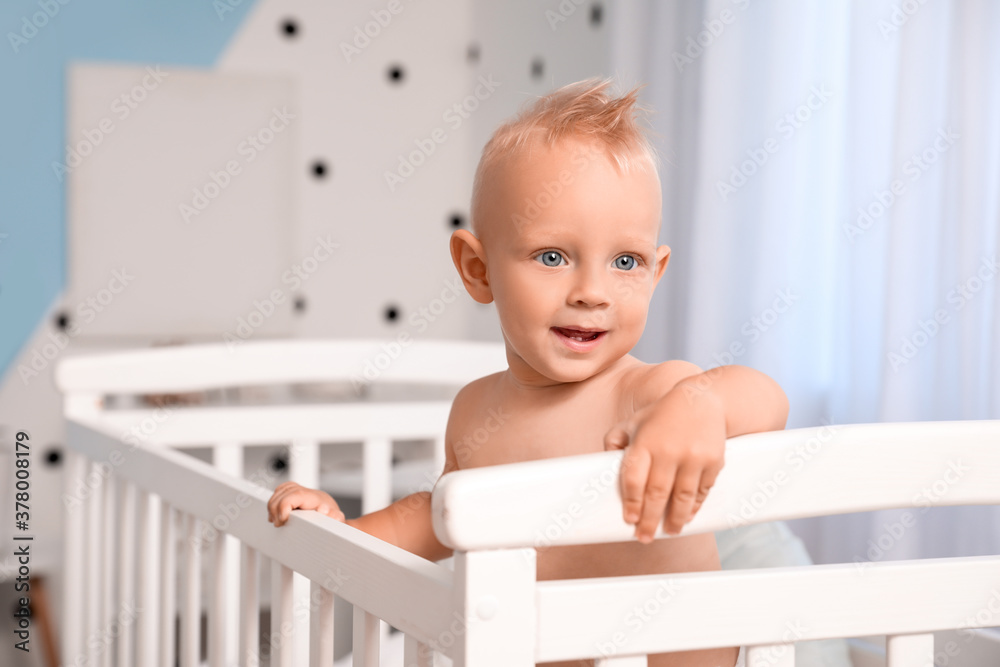 Cute little baby in bed at home