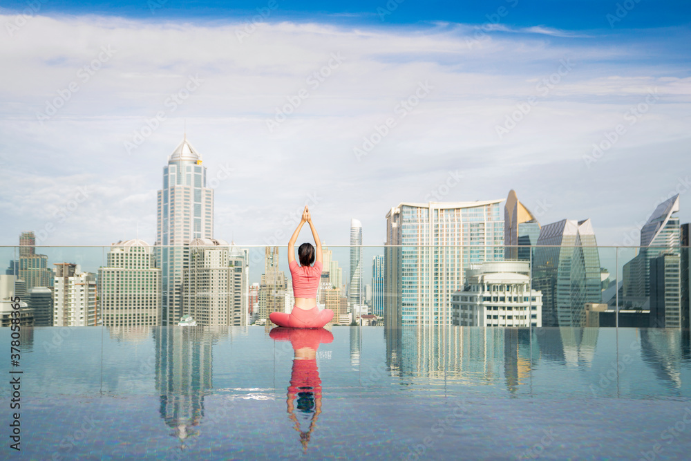 Asian beautiful woman in pink sports uniform doing a yoga exercise