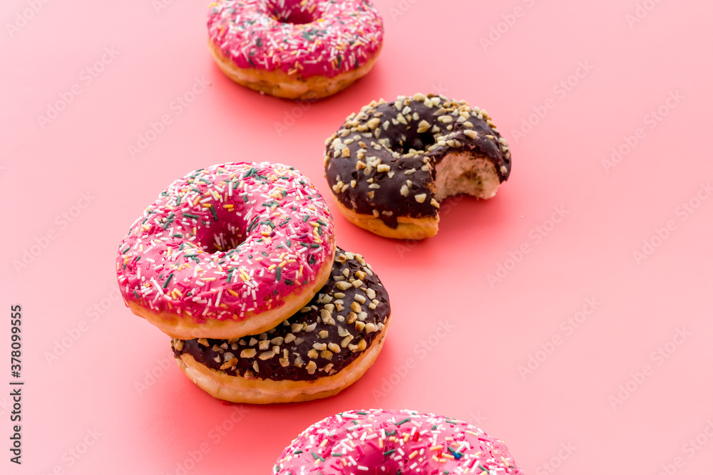 Colorful donuts close up, glazed and sprinkles bakery