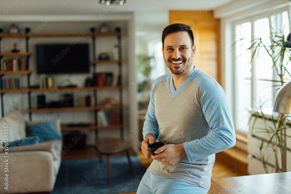 Handsome smiling man in pajamas, portrait.