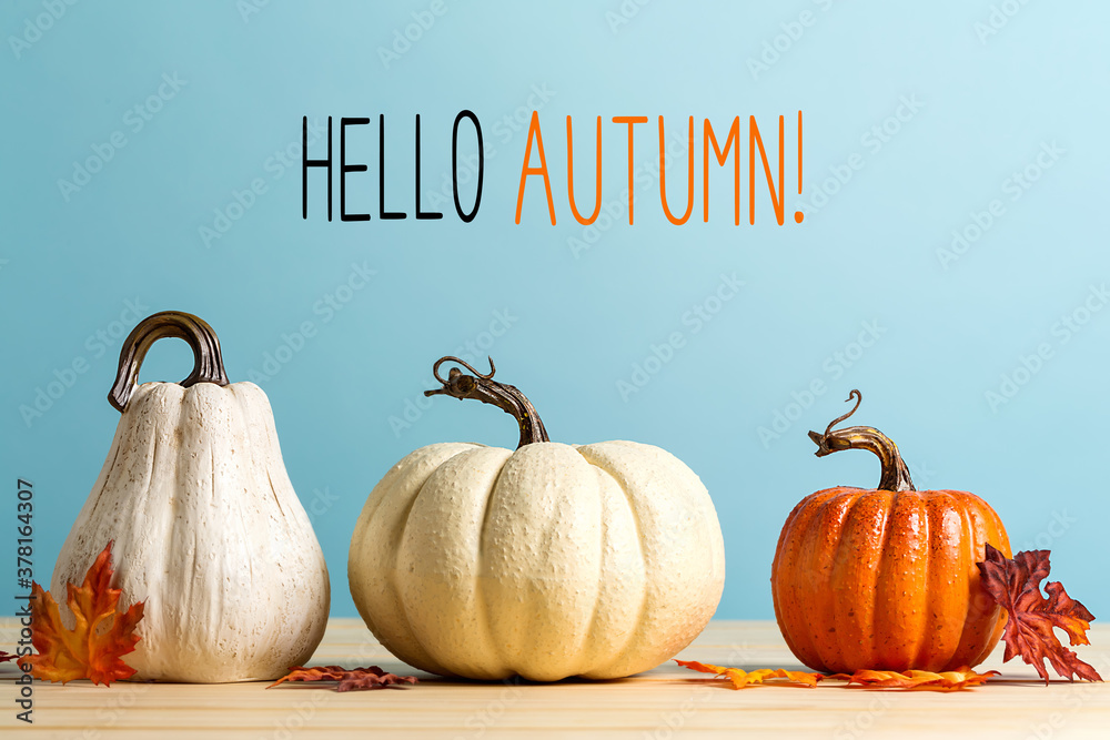 Hello autumn message with pumpkins on a blue background