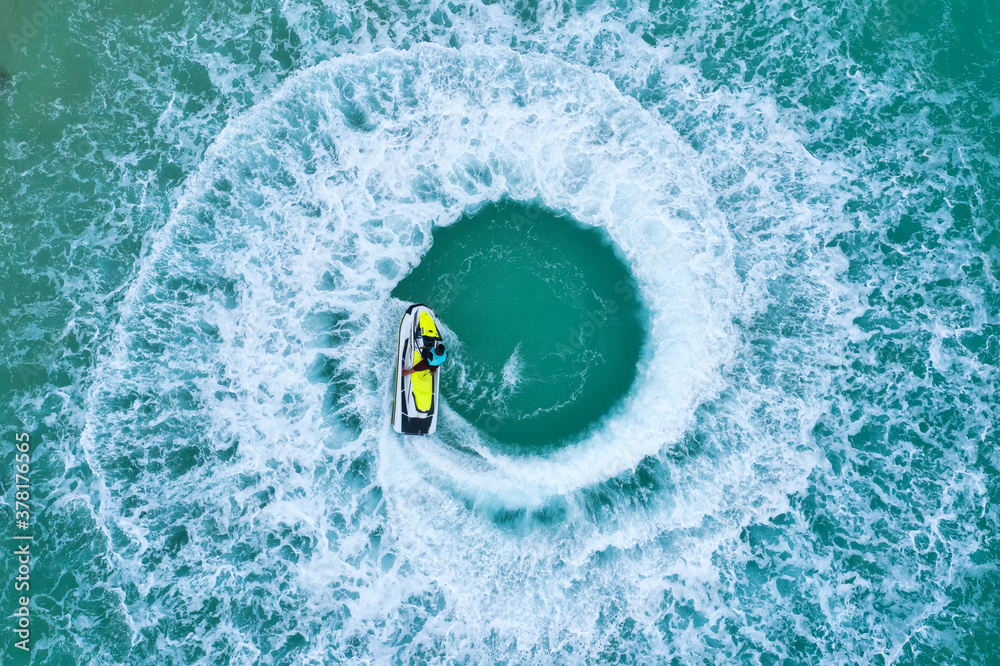 People are playing a jet ski in the sea.Aerial view. Top view.amazing nature background. The color o