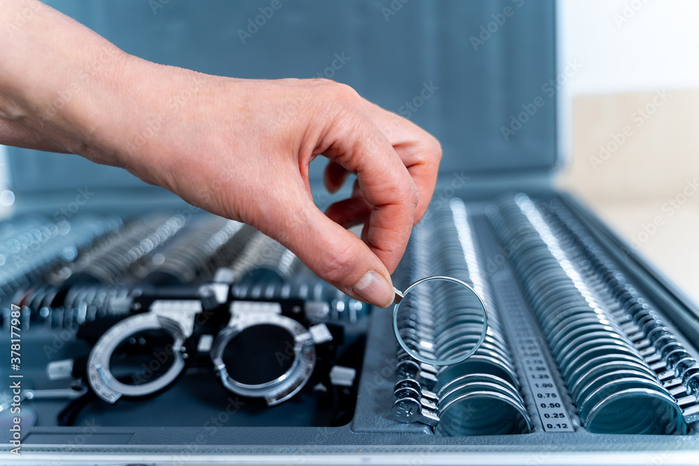 Set of corrective lenses. Eye test glasses set. Ophthalmology concept. Hand holding lenses.