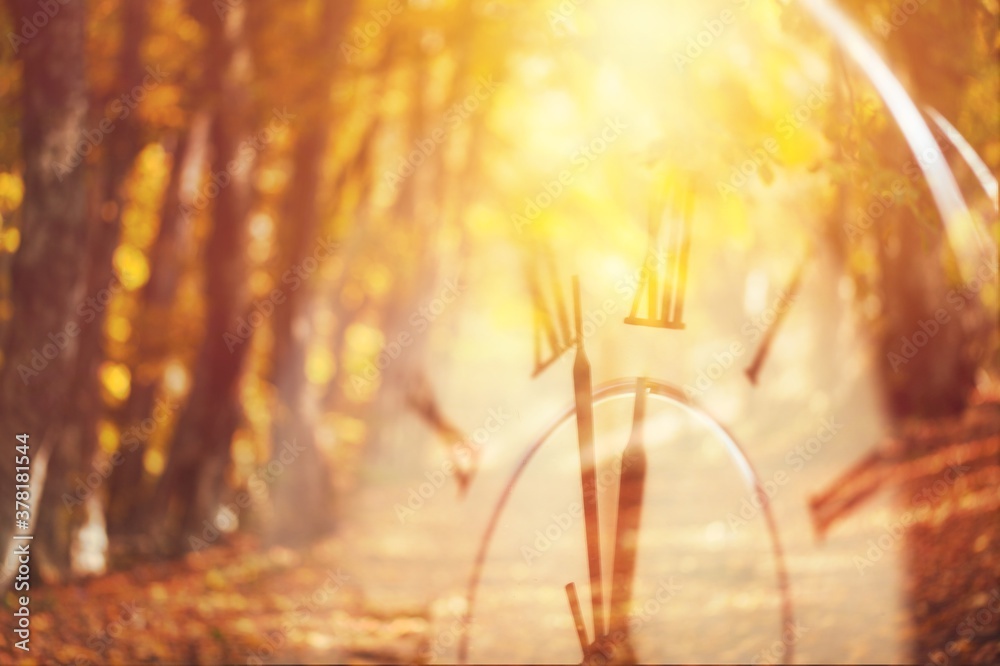 Photo of retro vintage clock on autumn landscape background