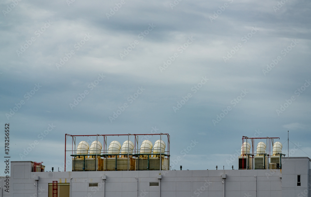 Cooling tower on roof top of building. Cooling system. Air cooled water chiller. Industrial cooling 