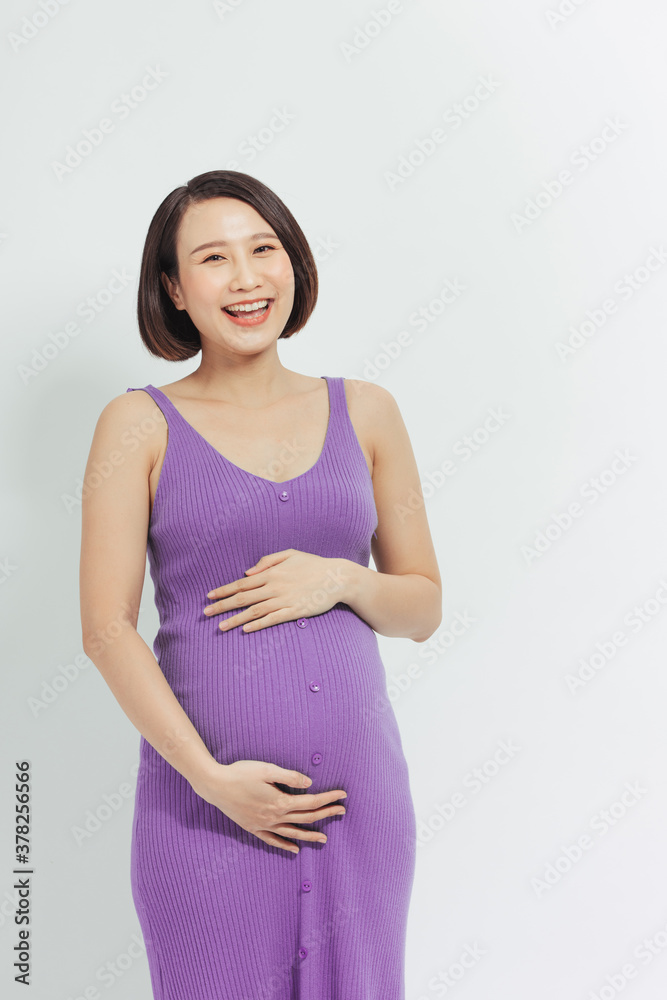 Young smiling beautiful pregnant woman in dress