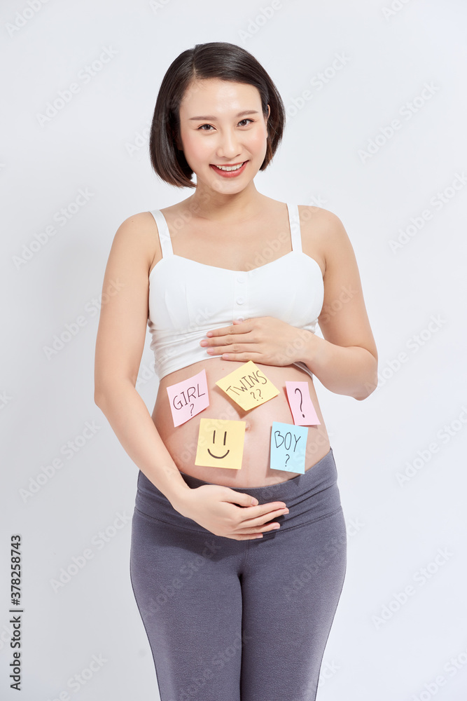 Asian pregnant woman with sticky note on her belly