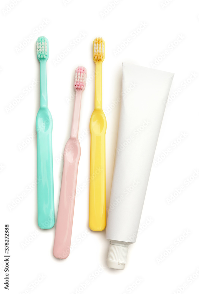 Tooth brushes and paste on white background